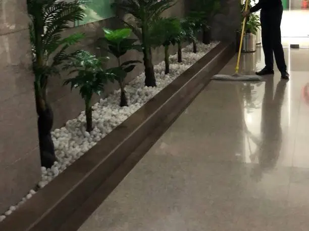 Commercial Office Cleaning Service crew sanitizing shared desks and glass doors in a Kaufman - TX office