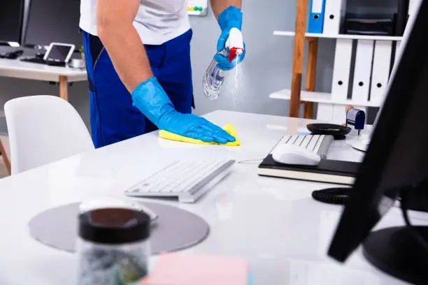 Office cleaners preparing Addison reception area and workstations before staff arrival